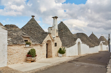 Fototapeta na wymiar Alberobello, Puglia, Italy: Typical houses built with dry stone walls and conical roofs of the Trulli, in a beautiful day