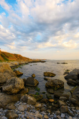 pebble coast at sunrise. gorgeous view of seascape on a cloudy morning. relax and recreation at the sea
