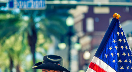 Masked people along Mardi Gras Parade in Bourbon Street. Mardi Gras is the biggest celebration the city of New Orleans hosts every year