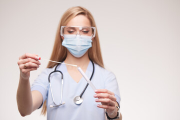 Doctor, covid test and medical expert working in hospital, analysis of virus results and face mask for safety in clinic. Hands of a nurse doing professional corona testing