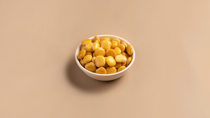 salted lupins in white bowl standing on beige background