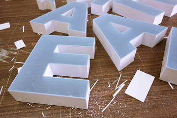 Production of outdoor advertising letters from PVC plastic and plexiglass.Advertising production of logos.Gluing letters for an inscription.