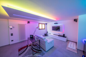 Modern room with bight led strips light. Tv, monitor and sofa