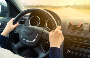 Driving with a car . View from car inside. Multi steering wheel with woman hands