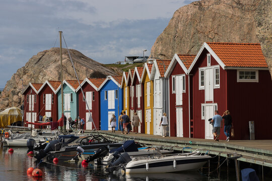 Beautiful boardwalk called Smögenbryggan with colorful fishing huts at the picturesque Swedish coastal town of Smögen.