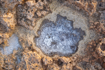 Remains of salt when seawater evaporates in rocks, a mineral rich in sodium.