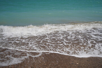 waves on mediterranean sea with pebble beach