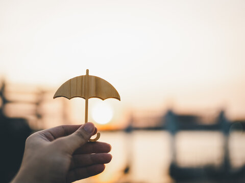 Hand Of Man Holding An Umbrella Symbol. Insurance Concept, Family Life Insurance And Policy Concepts