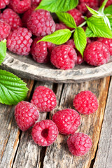 Organic raspberries with green leaves