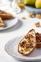 Pear with blue cheese, nuts and honey. Pears baked with blue cheese, nuts, honey. French cuisine. Vegetarian lunch. Roasted pears with cheese.