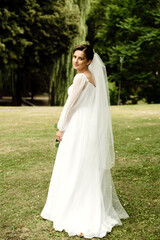 beautiful bride with a sweet smile. portrait of the bride in nature. wedding day concept. bride waiting to meet groom