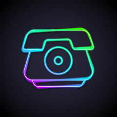 Glowing neon line Telephone handset icon isolated on black background. Phone sign. Vector