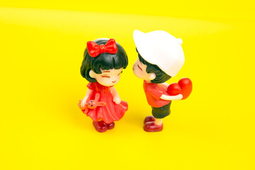 miniature people. figures for the game. romantic couple of young people. A boy lovingly gives his heart to a cute girl