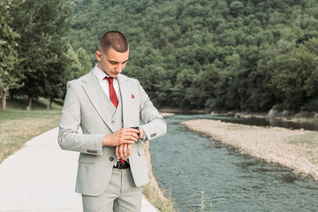 Young teenage boy looking at his watch. Ready for a prom night. © stivog