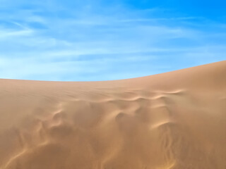Untouched natural sand dunes with blue sky good for nature background