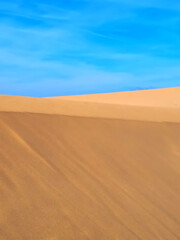 Fototapeta na wymiar Untouched natural sand dunes with blue sky good for nature background