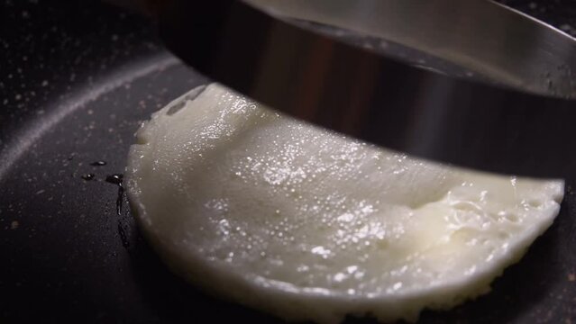 Mold is removed from a protein that is fried in a pan