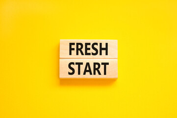 Fresh start and motivational symbol. Concept words Fresh start on beautiful wooden block. Beautiful yellow table yellow background. Business motivational and Fresh start concept. Copy space.