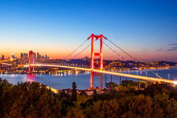 Fototapeta na wymiar Istanbul sunset from most famous and touristic destination Nation Park in Nakkastepe. 15th July Martyrs Bridge (15 Temmuz Sehitler Koprusu). Istanbul Bosphorus Bridge Romantic landscape Istanbul City 