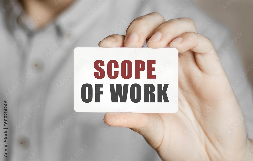 Poster card with text scope of work in a man's hand