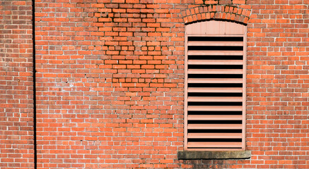 Background from brick building wall with ventilation window with copy space