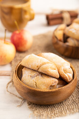 Homemade sweet cookie with apple jam and cup of coffee on white wooden. side view, selective focus.