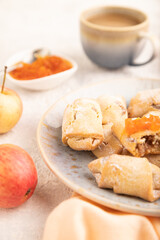 Homemade sweet cookie with apple jam and cup of coffee on gray concrete. side view, selective focus.