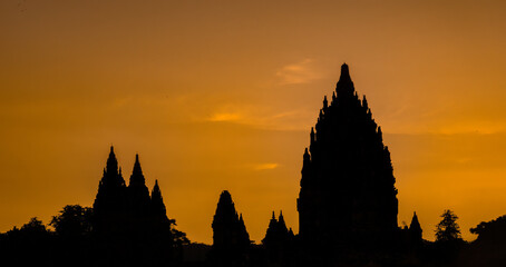 Sunset over the ancient temple ruins of Prambanan (Candi Prambanan) a 9th-century Mahayana Buddhist...