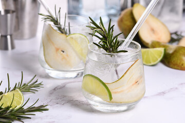 Gin Cocktail with lime, rosemary, ripe pear and tonic. This refreshing, organic drink is full of vibrant flavors and aromatic herbs.