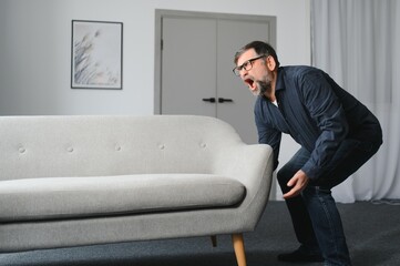 Senior man is suffering from pain in lower back at home