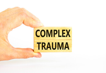 Complex trauma symbol. Concept words Complex trauma on wooden block. Beautiful white table white background. Doctor hand. Business psychology complex trauma concept. Copy space.