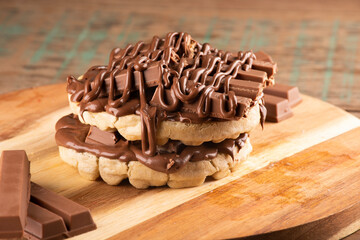 double waffle with chocolate coating on chocolate bars on rustic wooden table