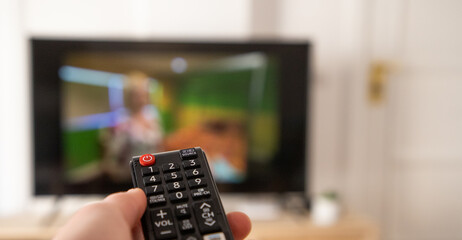 hand with remote control for tv set