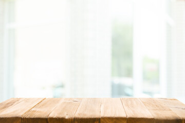 Empty wooden table top on window blur and abstract with sunlight. For mounting product display or...