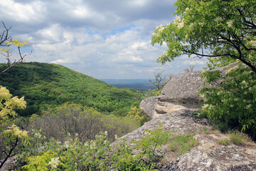 Rock monastery near the village of Royak (Bulgaria) and a view of the surrounding area

