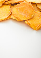 Naklejka na ściany i meble Dried large sweet mango slices on white background.Macro