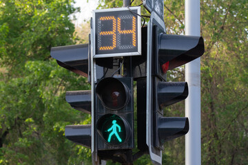 traffic light with a buming sign for pedestrians