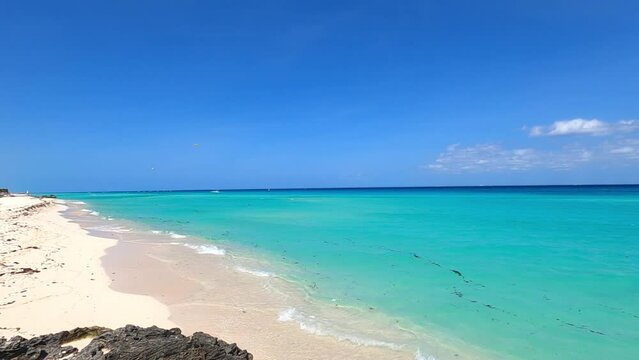 Slow motion footage with pam motion of a tropical beach with turquoise sea on a sunny summer day in Mexico