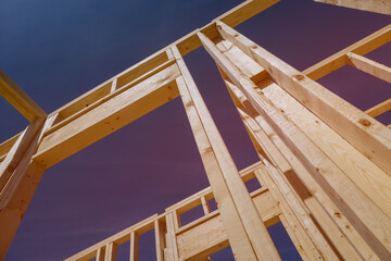 Building frame house made out of wooden beams stick framework for new construction