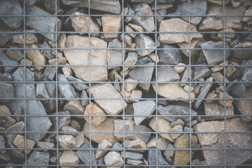 gabion from river stones. long stone fence