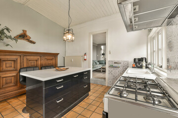 a kitchen with an island in the middle and wood cabinets on the other side, all over the counter space