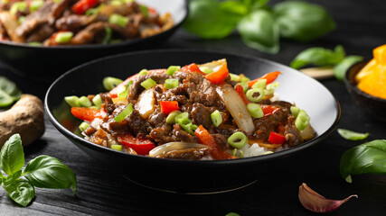 Stir fry Crispy Orange Beef with sweet peppers, onion and rice. Asian food