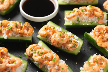 Cucumber Shrimp Sushi Boats with Spicy Mayo, Rice, Chives and sesame seeds
