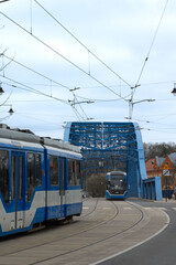 Blue trams on the blue bridge.