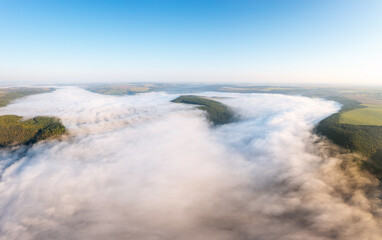 A fantastic bird's-eye view of the valley covered with thick fog.