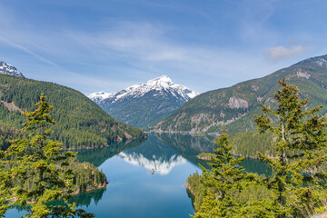 Fototapeta na wymiar Landscape of Diablo Lake in the Snowcapped North Cascades Mountains and Forest with Davis Peak in the Background in Whatcom County, Washington, USA