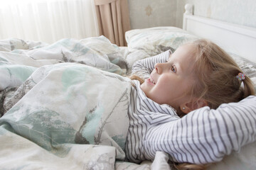 Little cute kid sleeping in the bed. Concept of rest at home