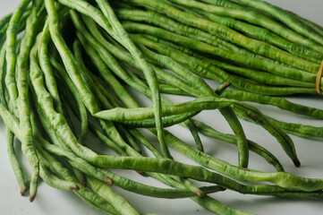 A bunch of raw long beans isolated on a white background