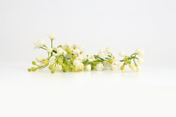 Lily of the valley flower bouquet on light beige background.