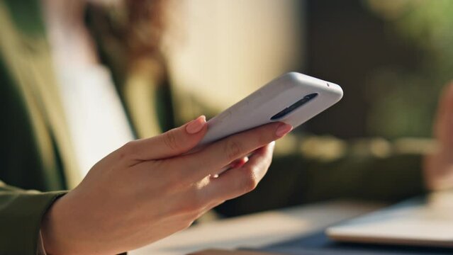 Woman hand taking telephone to answer call indoors close up. Girl speaking phone